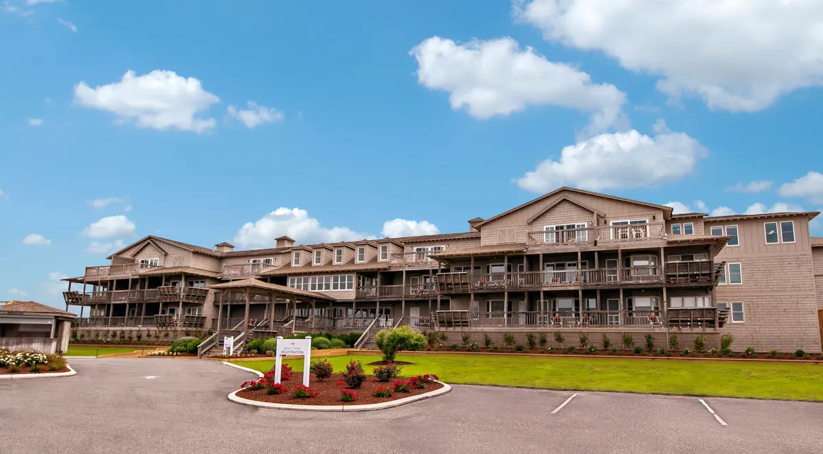 A broad exterior view of the property, showcasing the building's balconies surrounded by lush landscaping. The perspective highlights how each balcony offers privacy, beautiful views, and a connection to the outdoors—the perfect setting for exclusive relaxation.